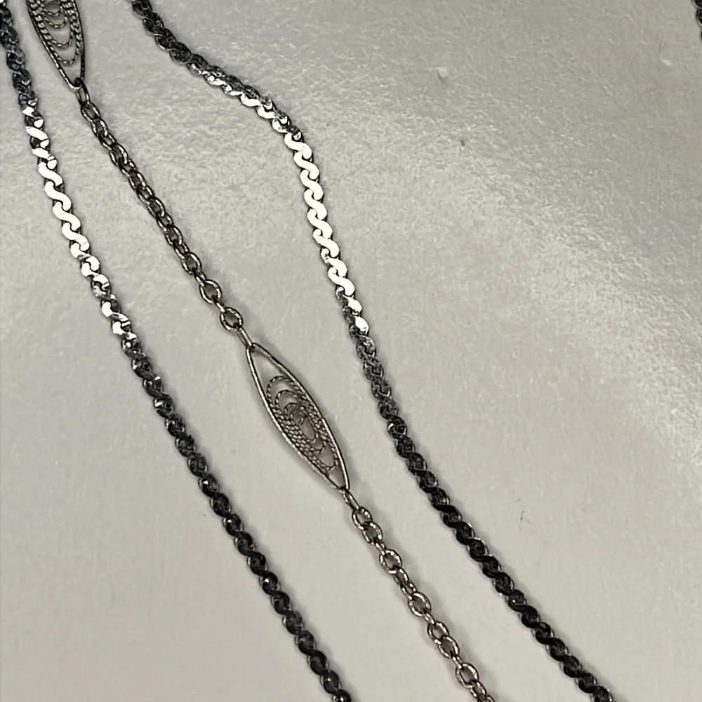Napier 3 strand silver graduating length chain necklace.